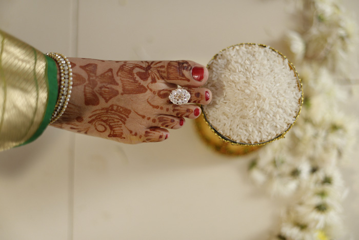hindu bride pushes rice pot